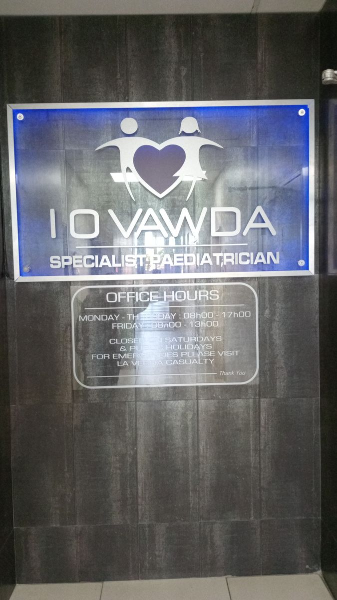 Backlit I O Vawda Specialist Paediatrician sign inside La Verna Medical Centre